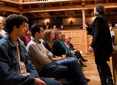 Luke Eddy as Hamlet in front of the stage soliloquising to the front row audience