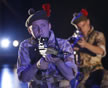 Scottish solders with the red plumes in their berets kneel with rifles poised and what looks like car headlights shining from the back